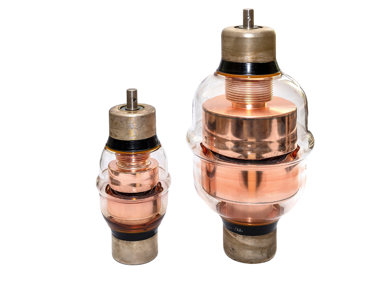 Two variable high voltage capacitors of different sizes with copper wiring.